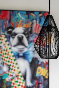 a dog wearing a bow tie and a lamp at Stara Cegielnia Lake View Apartment by Renters Prestige in Poznań