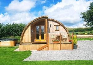 a hobbit house with a large arched roof at Oak View in Llanddeusant