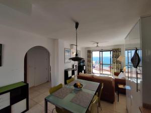 a living room with a table and a couch at R1371 Capistrano Playa 417 in Nerja