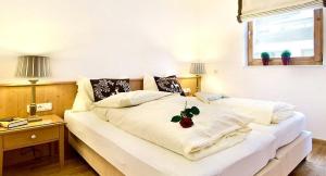 Posteľ alebo postele v izbe v ubytovaní Alpen Lodge