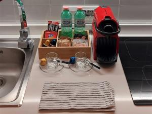 un bancone della cucina con lavandino e due bicchieri di Porta Venezia Lifestyle Home Milano a Milano