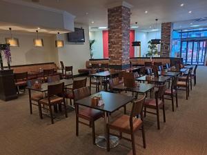 a dining room with tables and chairs in a restaurant at ibis Carlisle City Centre in Carlisle