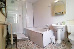 a bathroom with a shower and a tub and a sink at escape the ordinary - private self catered holiday home stay in Dorchester