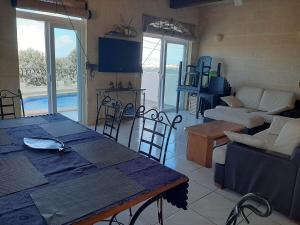 a living room with a table and chairs and a couch at In-Nuffara Farmhouse, Nadur Gozo in Nadur