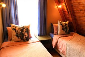 a bedroom with two beds and a window at 3 Bedroom chalet in Graskop