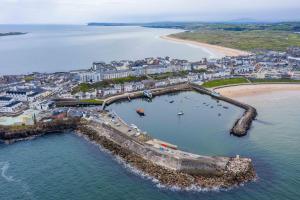 an aerial view of a city and a beach at Harbour View Apartment at Royale Court Apartments Portrush in Portrush