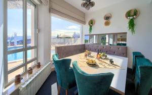 a dining room with a table and chairs and a window at Villa PIANO in Pinezici