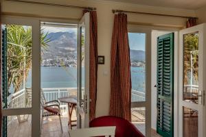 a room with a balcony with a view of the water at Detached Villa with stunning views in Njivice, Montenegro in Njivice