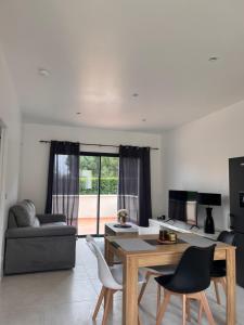 a living room with a table and chairs at Résidence Mk Evasion in Jonzac