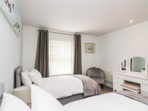 a bedroom with two beds and a window at 30 Dart Marina in Dartmouth