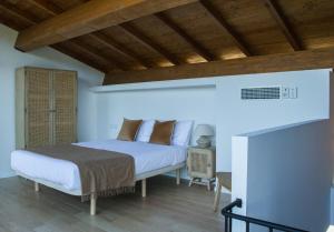 a bedroom with a bed and a fireplace at Casiñas do Sil in Cristosende