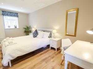 a bedroom with two beds and a mirror at The Asparagus Shed in Sleaford