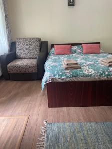 um quarto com uma cama e um sofá em Green House Inn em Călimăneşti