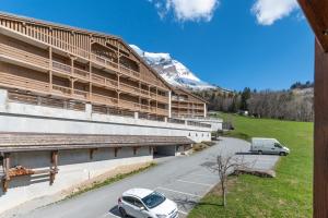 a white car parked in front of a building at La Ferme des Alpages - Proche pistes de ski in La Giettaz