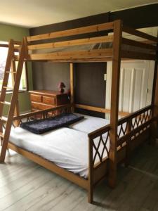 a bedroom with a bunk bed with a wooden bed frame at Location Sylvie Herve Vosges in Saulxures-sur-Moselotte