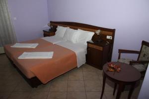 En eller flere senge i et værelse på Thea Dodoni