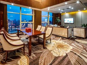 a conference room with a table and chairs and a television at Days Hotel & Suites China Town - Metro Line 2 - Nearby Wuyi Square ,Orange Island,Hunan Museum in Changsha