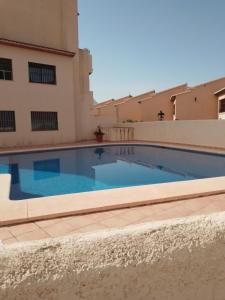 a swimming pool in front of a building at La Calma in Lliber