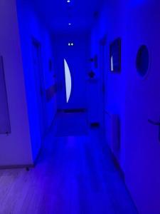 a blue room with a hallway with blue lights at Gîte calme et cosy d' Eole in Cornillon-Confoux