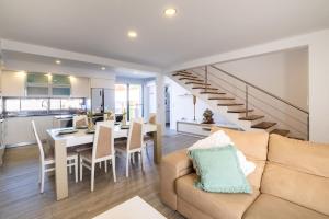 a living room with a couch and a dining room at Don Jose Ocean View Heated Pool in Lagoa