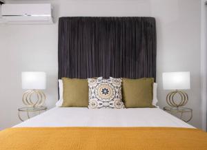 a bedroom with a large bed with two lamps at Don Jose Ocean View Heated Pool in Lagoa +72 photos