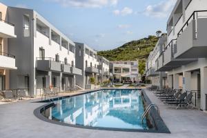 a swimming pool in the middle of a building at Sunrise Village Hotel - All Inclusive in Platanias