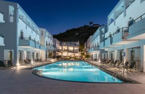 a swimming pool in the middle of a building at Sunrise Village Hotel - All Inclusive in Platanias