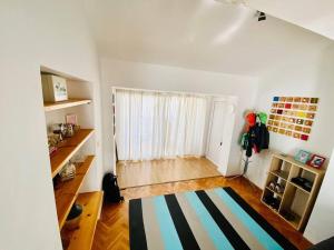 Pet-friendly two-room family apartment in magical Bale في بال: غرفة معيشة مع سجادة مخطط ونافذة
