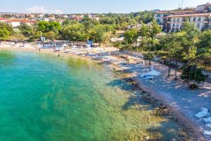 an aerial view of a beach with chairs and umbrellas at Apartment Marko by KRALJ TRAVEL in Malinska