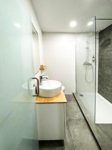 a white bathroom with a sink and a shower at Beach & City - Trafaria in Trafaria +37 photos