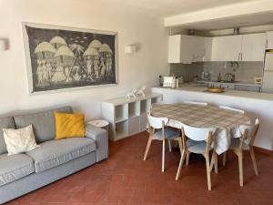 een woonkamer met een bank en een tafel en een keuken bij Altura Beach in Altura
