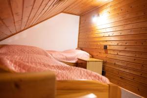 a bedroom with two beds in a wooden wall at Sophienmühle II Nähe Carolinensiel in Wangerland