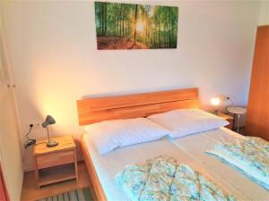 a bedroom with a bed and a picture on the wall at Ferienwohnung Hermann in Techelsberg am Wörthersee in Karnten