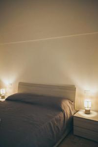ein Schlafzimmer mit einem Bett und zwei Lampen an Tischen in der Unterkunft La Casetta al n°30 in Monopoli