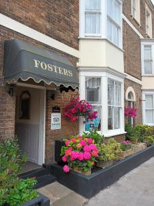 a store with flowers in the front of a building at Fosters Guest House in Weymouth