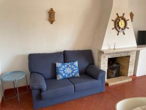 a blue couch in a living room with a fireplace at Altura Beach in Altura