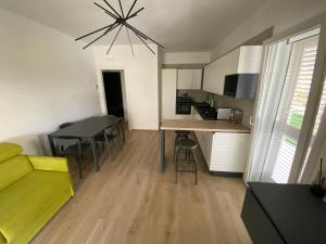 a living room with a yellow couch and a table at TOT apartment in Policoro