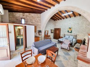 a living room with a couch and a table at Aphrodite's Pool Retreat in Skarinou