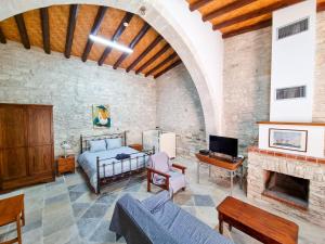 a living room with a bed and a fireplace at Aphrodite's Pool Retreat in Skarinou
