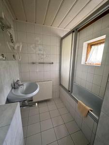 a bathroom with a sink and a shower at Gasthof Schönblick Rußbach in Gseng