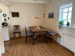 a dining room with a table and two chairs at The Old Store in Hellur