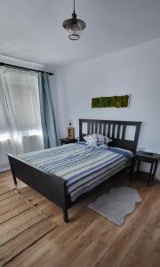 a bedroom with a bed with a blue comforter at Casa Albinuța in Călimăneşti