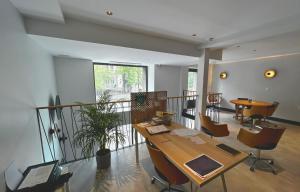 an office with a table and chairs and a balcony at Doma Zagreb Aparthotel in Zagreb
