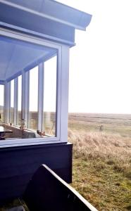 a view from the window of a house in a field at Knaldhytten in Blåvand