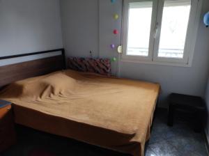 a small bedroom with a bed in a room with two windows at My house in Komotini in Komotini