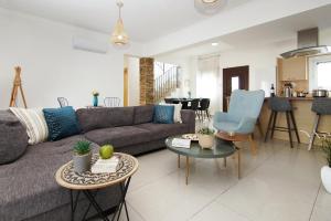 a living room with a couch and a table at Villa Alyson in Paralimni