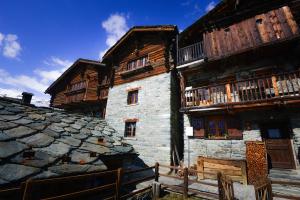 a large wooden building with wooden balconies on it at Rifugio Vieux Crest in Champoluc