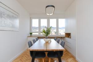 a dining room with a wooden table and chairs at Apartment Skopljak + free garage in Sarajevo