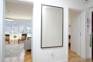 a living room with a white door with a mirror at Apartment Skopljak + free garage in Sarajevo