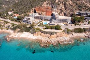 an aerial view of a hotel on a cliff next to the water at Résidence Les Calanques in Ajaccio